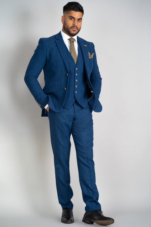 Introducing our new Orson tweed three-piece suit to our formal range. This suit is a great choice for almost any occasion from that special day to a normal day at the office it composes a mix of 70% Polyester and 30% Wool. The fitting for this suit is a slim fit with 2 internal pockets and a Brass coloured Cavani pin on the Lapel. - Party Wear |m Office Wear