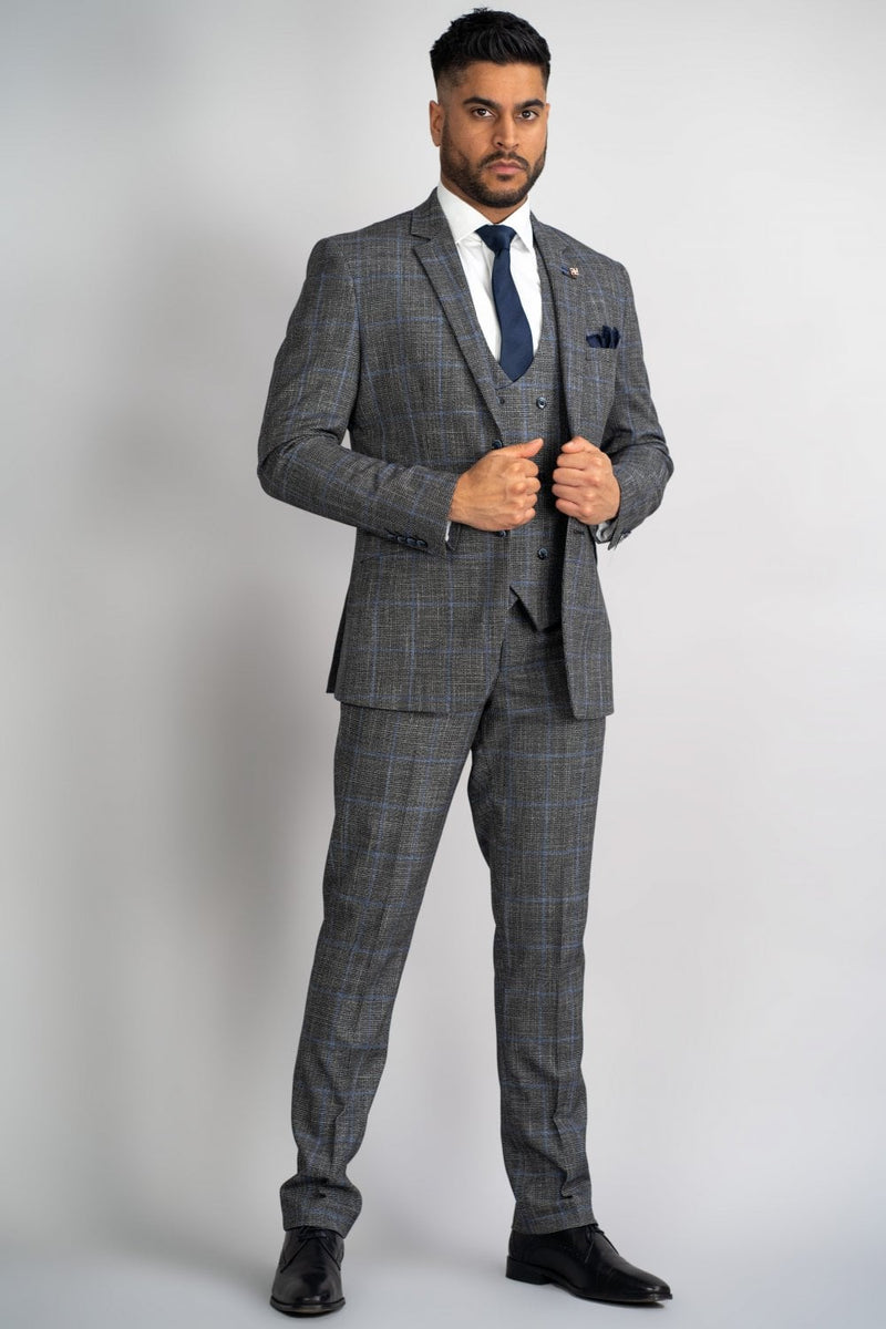 Perfect for that special occasion, this Power Grey Check suit will keep you cool and stylish. Its subtle blue check is perfect for that Autumn vibe. Cut to form the slender silhouette everyman wants. Its neutral Grey colour contrasts flawlessly with its bright Orange Signature inner lining and the stylish House of Cavani Logo pin. - Party Wear | Office Wear