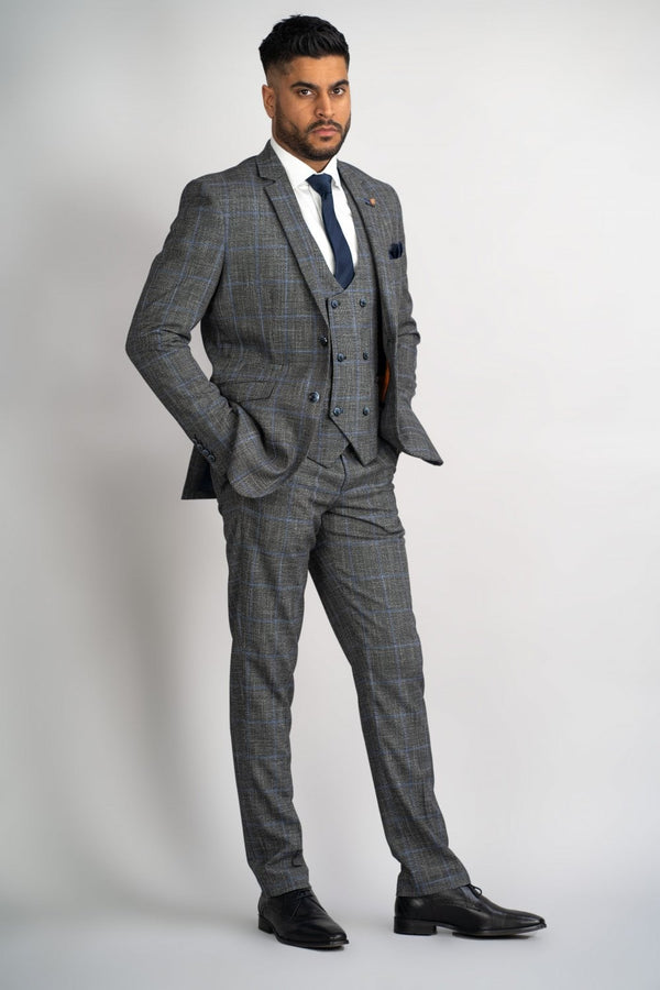 Perfect for that special occasion, this Power Grey Check suit will keep you cool and stylish. Its subtle blue check is perfect for that Autumn vibe. Cut to form the slender silhouette everyman wants. Its neutral Grey colour contrasts flawlessly with its bright Orange Signature inner lining and the stylish House of Cavani Logo pin. - Party Wear | Office Wear