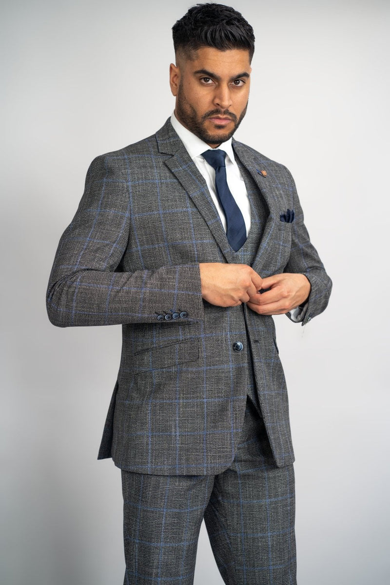Perfect for that special occasion, this Power Grey Check suit will keep you cool and stylish. Its subtle blue check is perfect for that Autumn vibe. Cut to form the slender silhouette everyman wants. Its neutral Grey colour contrasts flawlessly with its bright Orange Signature inner lining and the stylish House of Cavani Logo pin. -Party Wear | Office Wear
