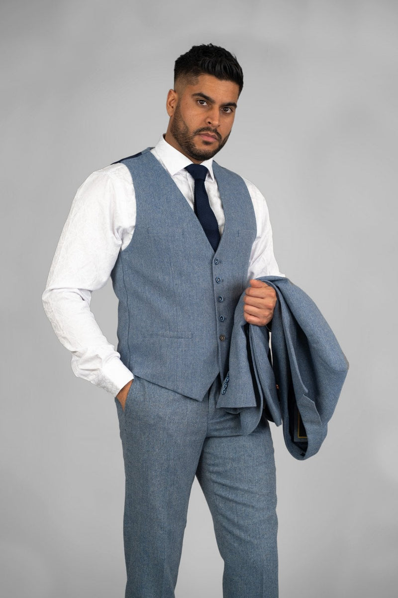 We are ecstatic to introduce our brand new style, Wells blue three-piece suit. This suit is perfect in every way possible. Get that sharp yet elegant look on your wedding day or impress your colleagues at the office with this slim-fitting stylish suit. - Party Wear :- Office Wear